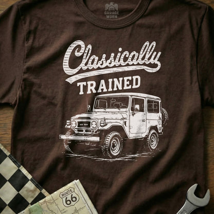 Brown t-shirt with "Classically TRAINED" and a white vintage Land Cruiser drawing.