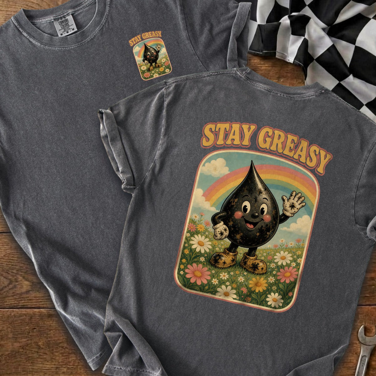 Shirt with "STAY GREASY" text and cartoon oil drop in a floral field.