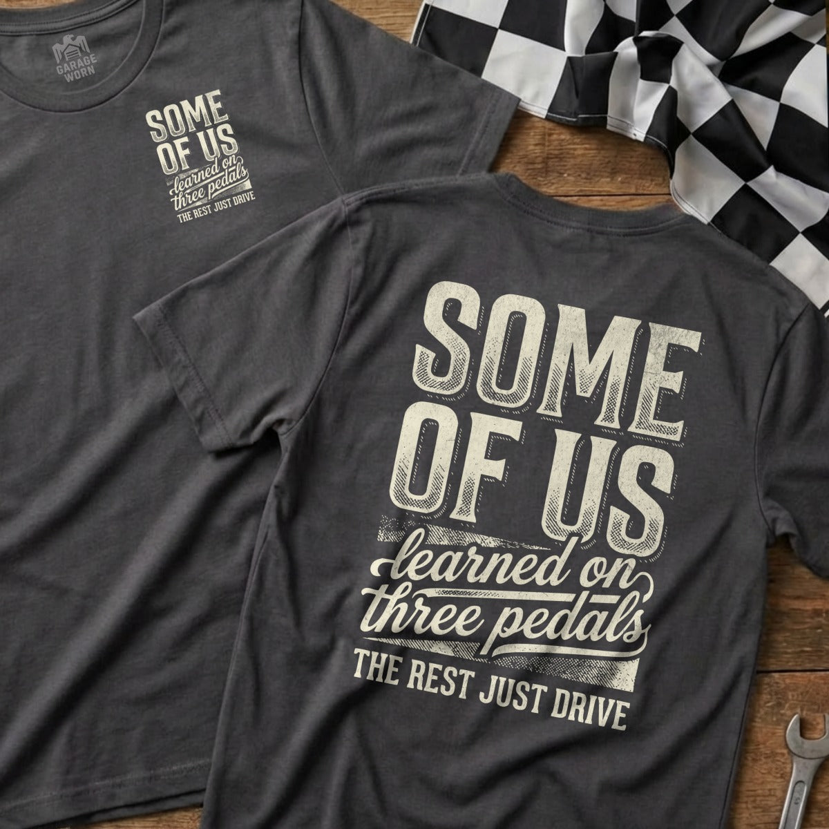 Two t-shirts with "Some of us learned on three pedals" text.