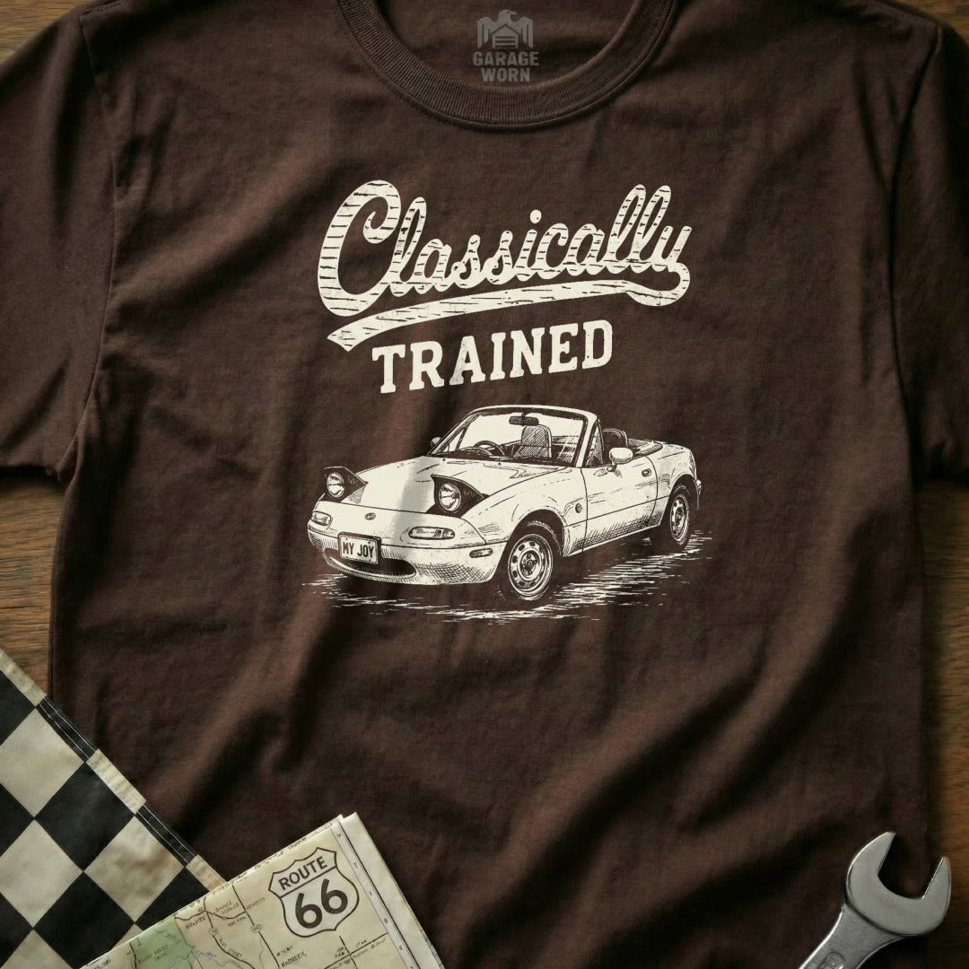 Brown t-shirt with "Classically TRAINED" text and white Miata convertible graphic.
