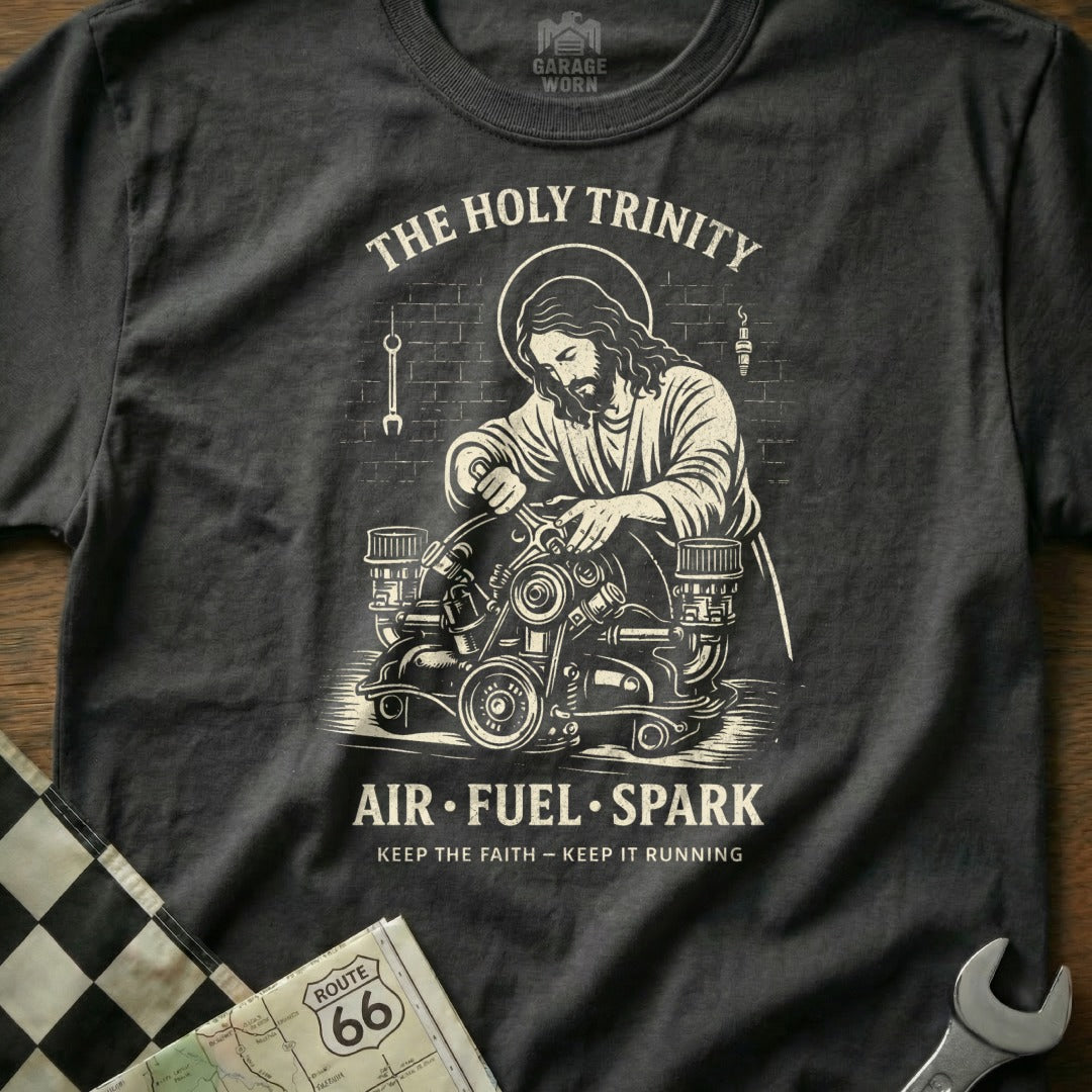 Jesus working on an engine, with text "The Holy Trinity" and "Air Fuel Spark".