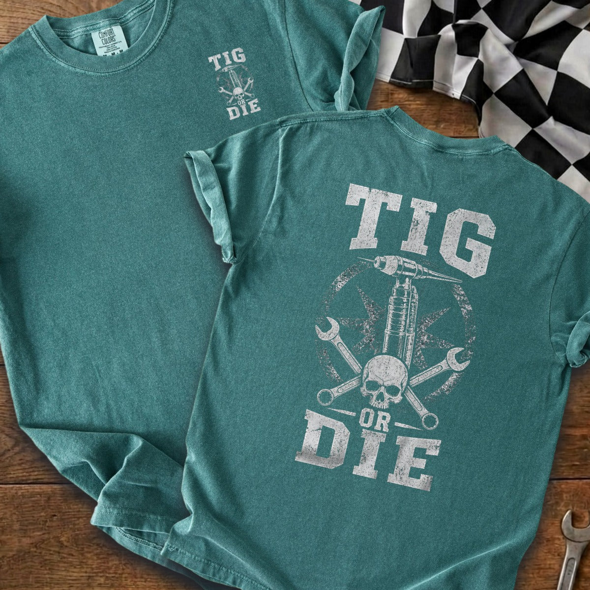 Teal t-shirt with "TIG OR DIE" graphic featuring a skull and welding torch.