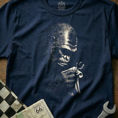 Monkey holding a wrench on a navy t-shirt with "Garage Worn" logo.