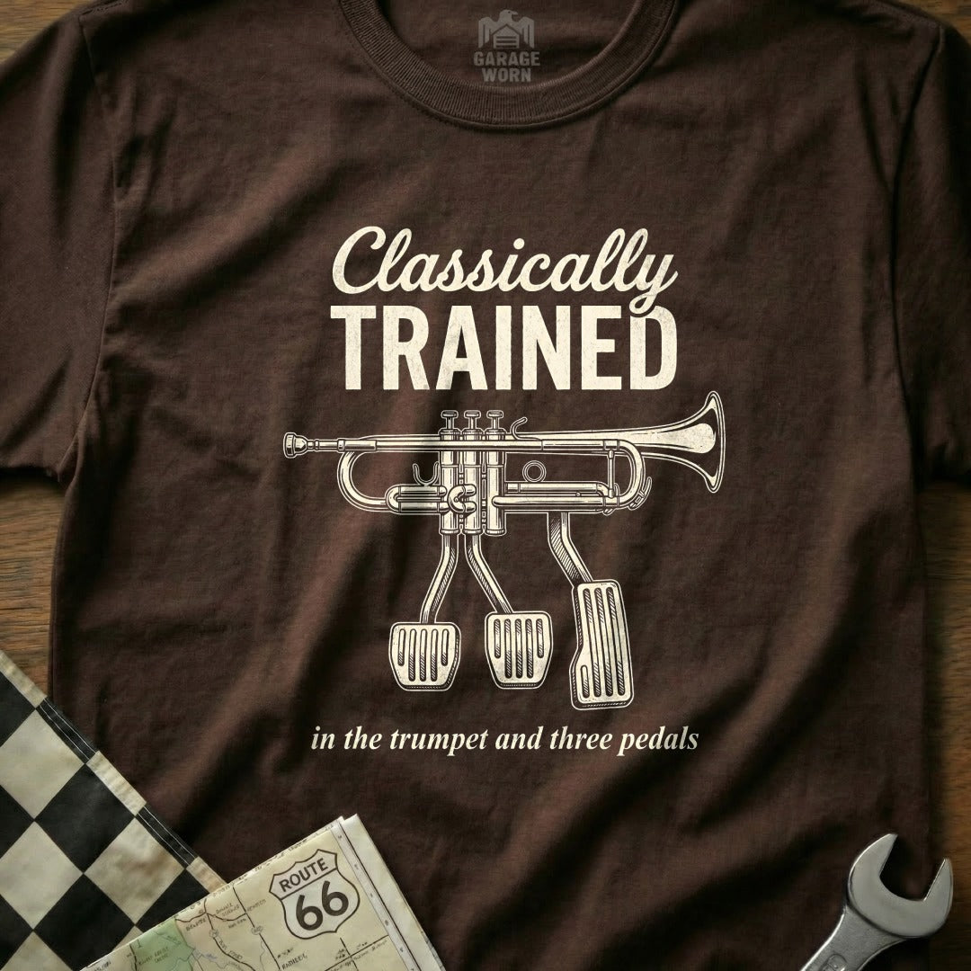 Brown t-shirt with "Classically Trained in the trumpet and three pedals" text and trumpet pedals graphic.