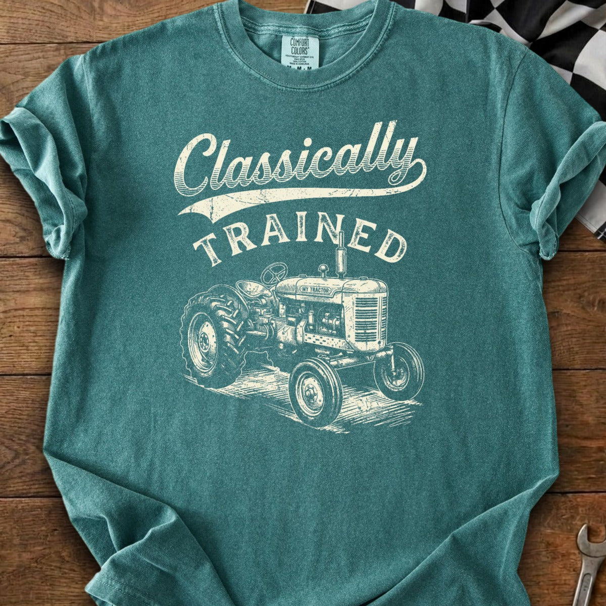 Teal t-shirt with graphic of vintage tractor and text "Classically TRAINED".