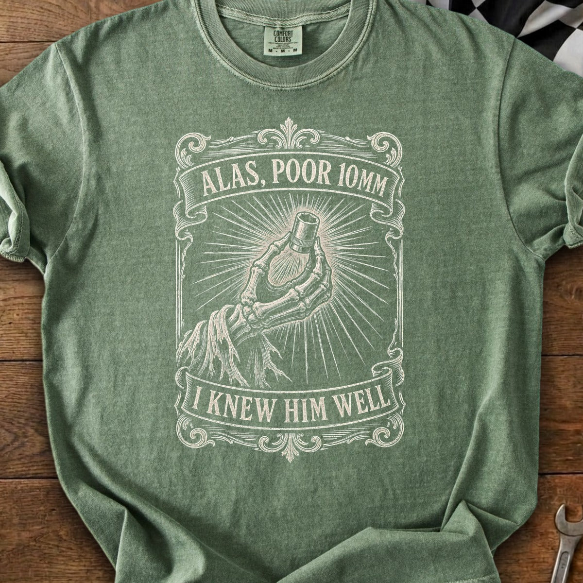 Green t-shirt with skeleton hand holding a 10mm socket and text.