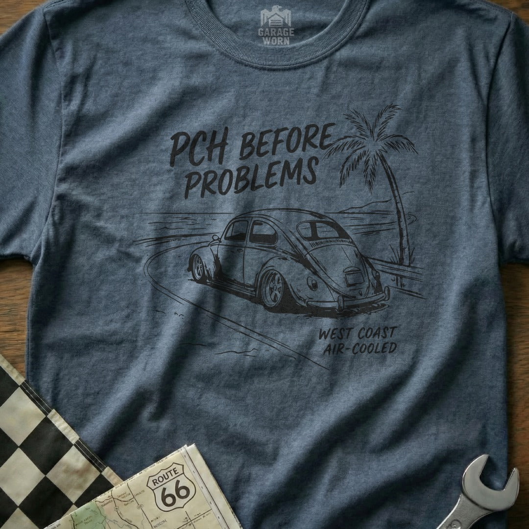 T-shirt with sketch of a Volkswagen Beetle on a coastal road, "PCH BEFORE PROBLEMS" text.