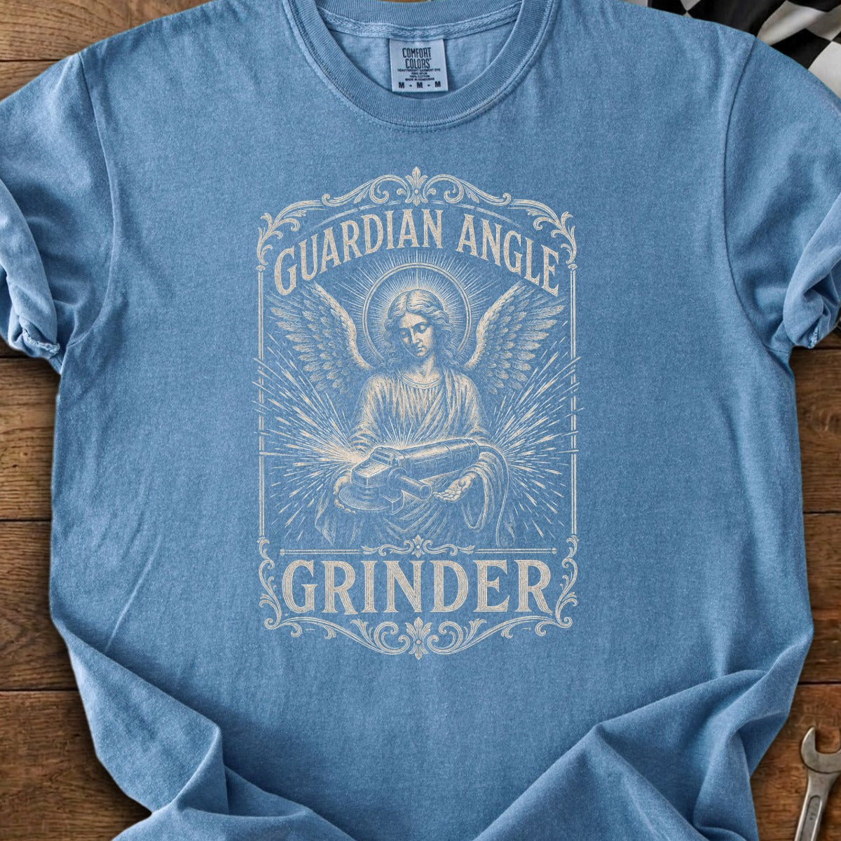 Guardian Angle Grinder graphic on a blue t-shirt.