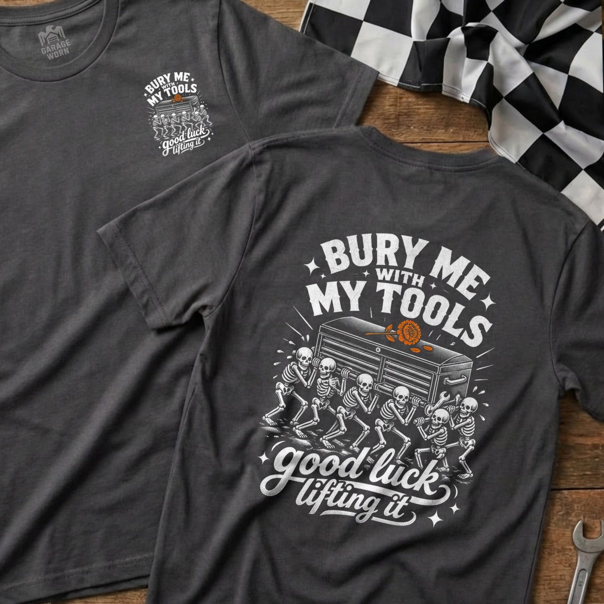 T-shirt with "Bury Me With My Tools, Good Luck Lifting It" graphic featuring skeletons.