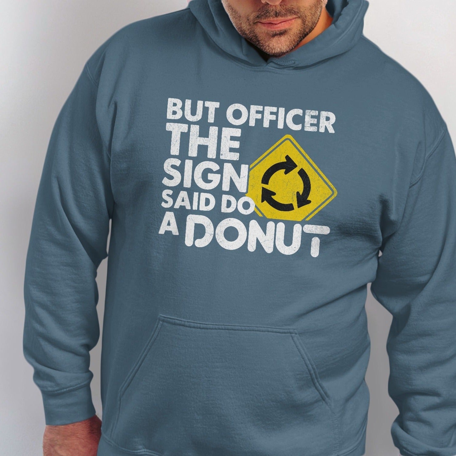Blue hoodie with white text "BUT OFFICER THE SIGN SAID DO A DONUT" and roundabout sign.