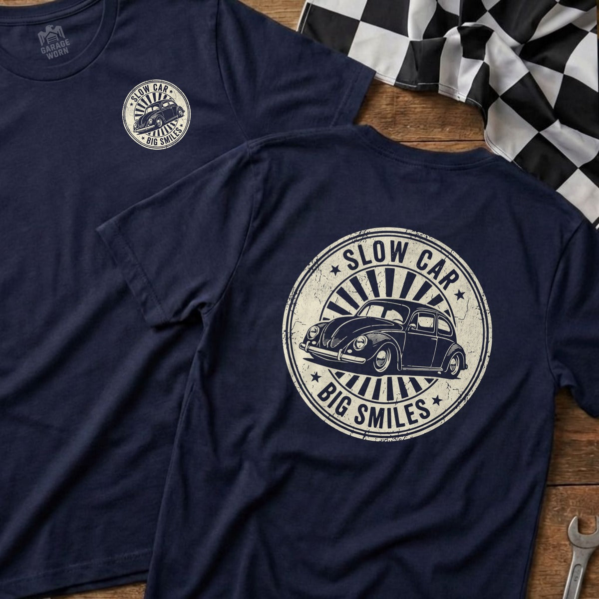 Navy t-shirt with circular graphic featuring a vintage Volkswagen Beetle and text "SLOW CAR BIG SMILES".
