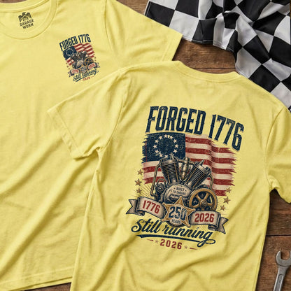 Yellow t-shirt with forged 1776 graphic featuring motorcycle engine and American flag.