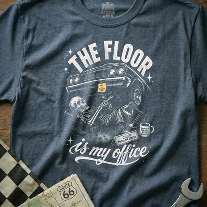 Skeleton mechanic under car with text "The floor is my office".