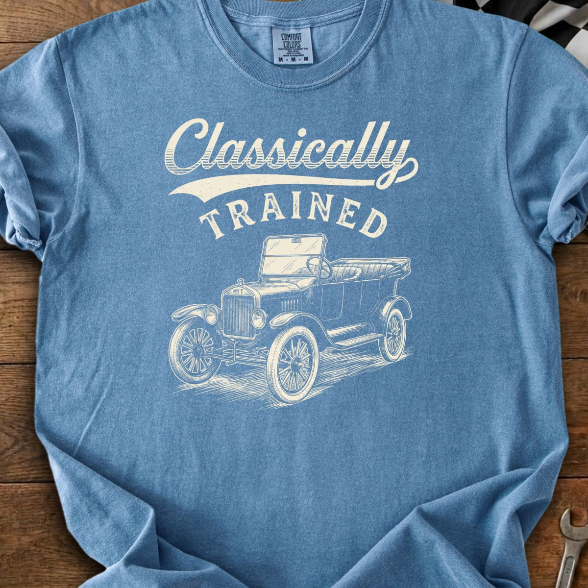 Blue t-shirt with "Classically TRAINED" text over a vintage automobile sketch.