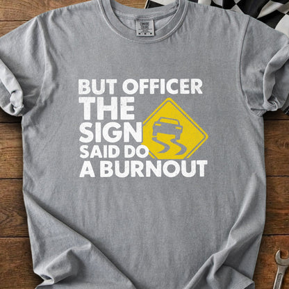 Gray t-shirt with white text and a yellow slippery road sign graphic.