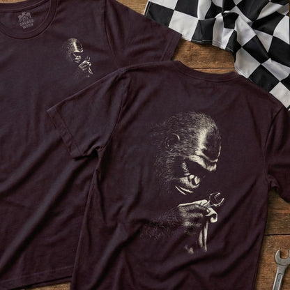 Gorilla holding a wrench, printed on a dark t-shirt.