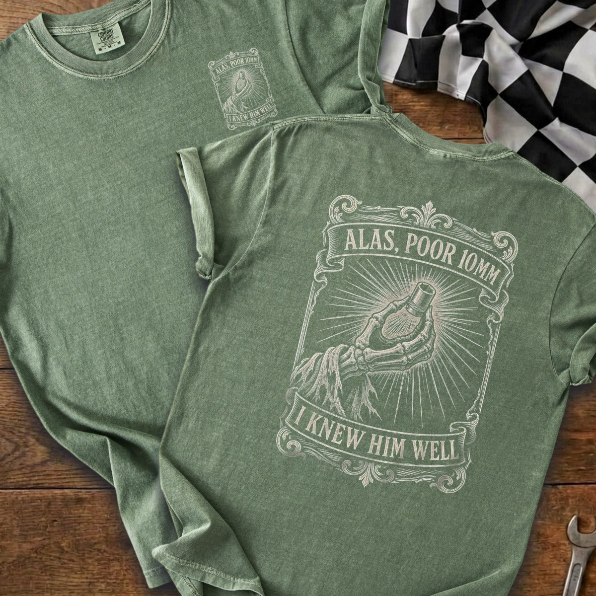 Green t-shirts display a graphic of a skeleton hand holding a bullet with text "Alas, Poor 10mm I Knew Him Well".