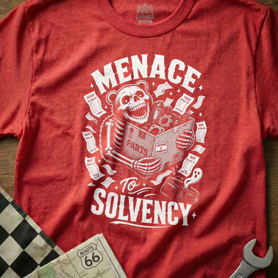 Red t-shirt with skeleton bear holding box of parts, "Menace To Solvency" text.