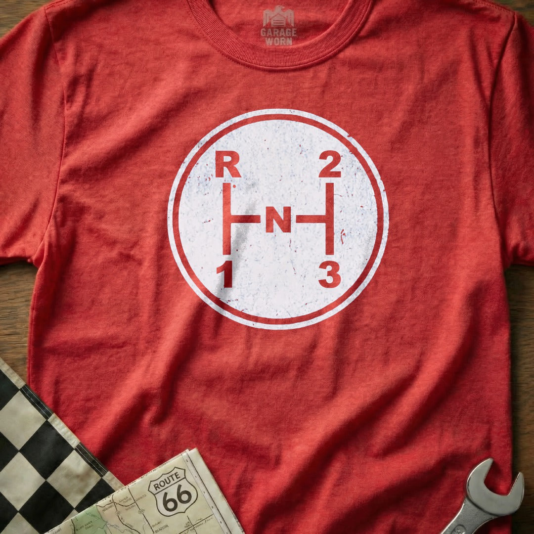Red t-shirt with vintage manual transmission shift pattern graphic and "Garage Worn" label.