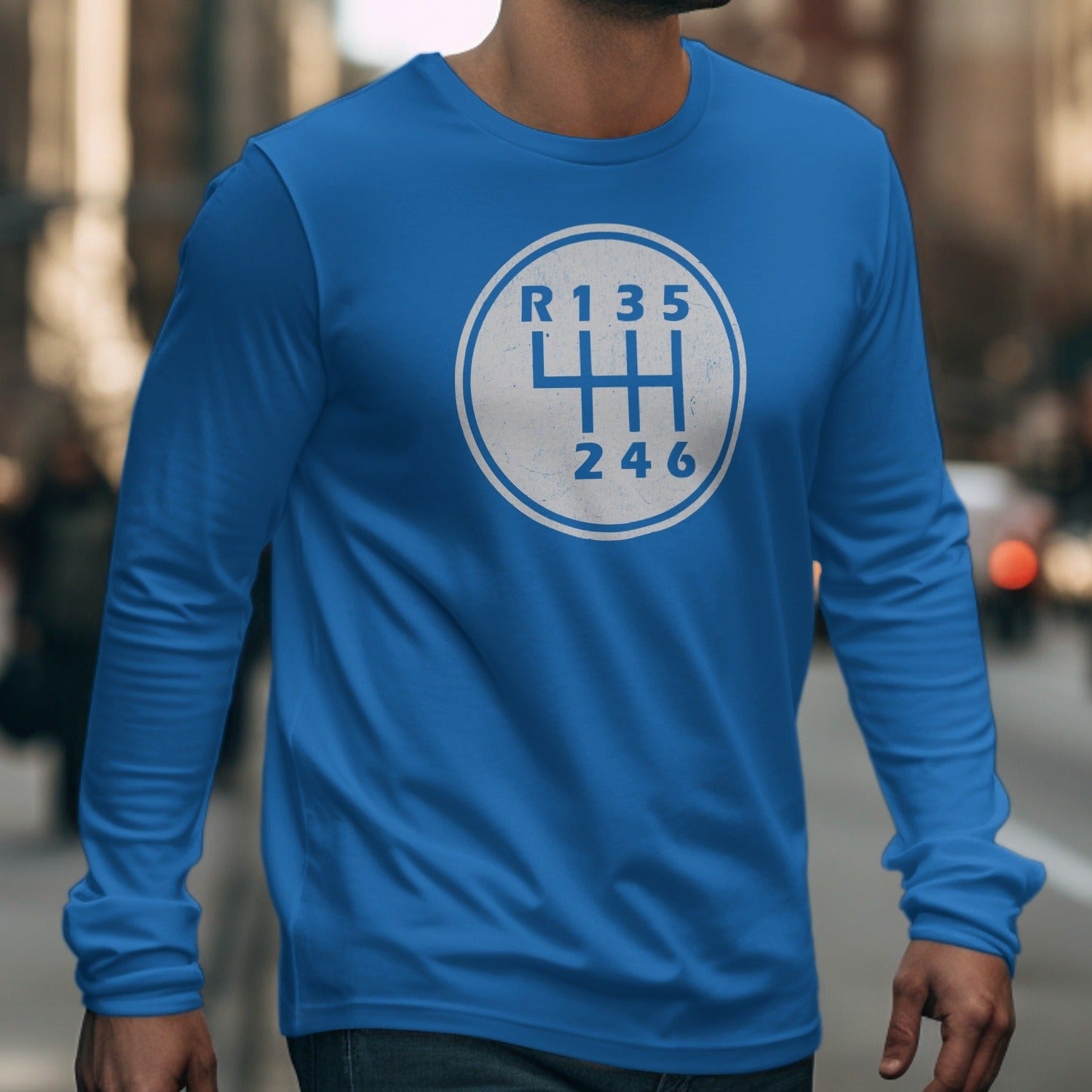 Blue long-sleeve shirt with a white manual six-speed gear shift pattern graphic.