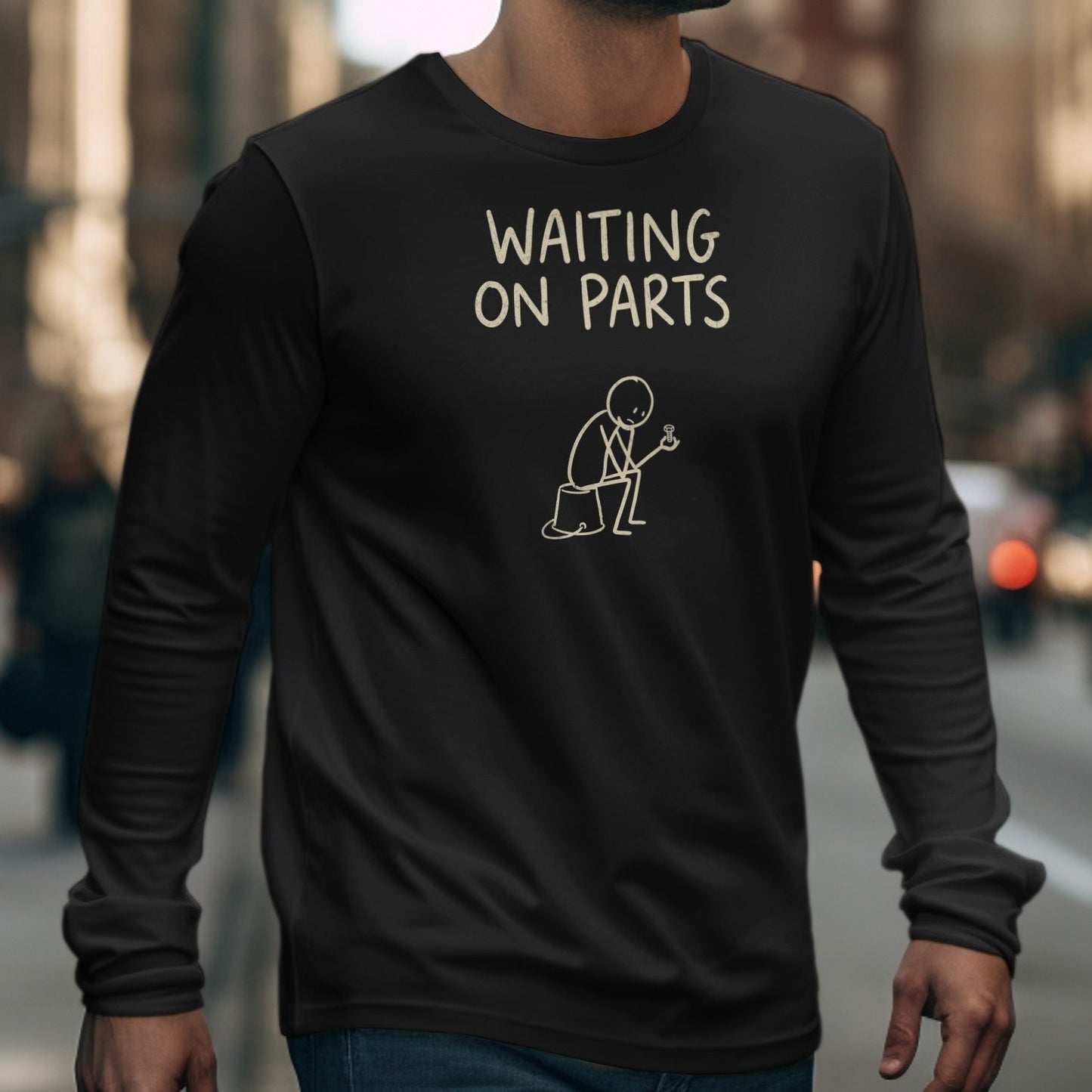 Black long-sleeve shirt with "WAITING ON PARTS" text and a stick figure holding a bolt.