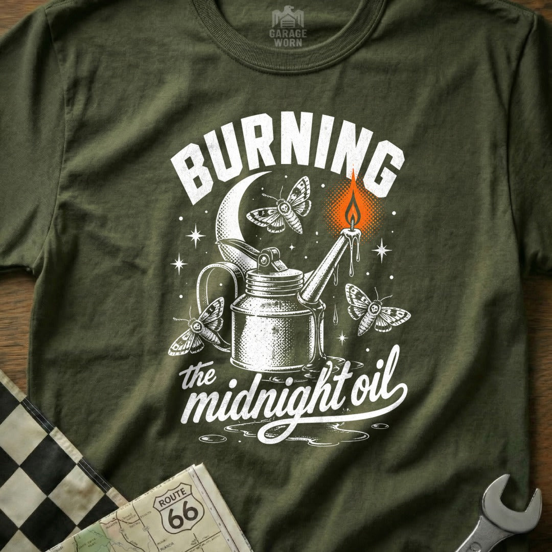 T-shirt graphic with "Burning the midnight oil" text, oil can, moths, and candle.