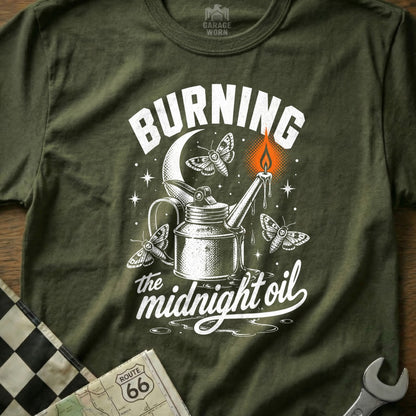 T-shirt graphic with "Burning the midnight oil" text, oil can, moths, and candle.