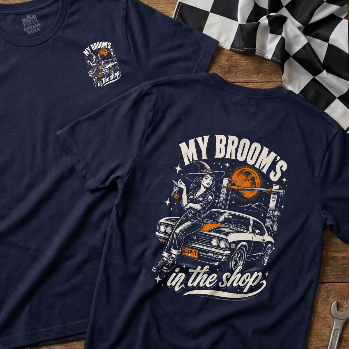 Navy t-shirt with witch and car graphic and "My Broom's in the Shop" text.