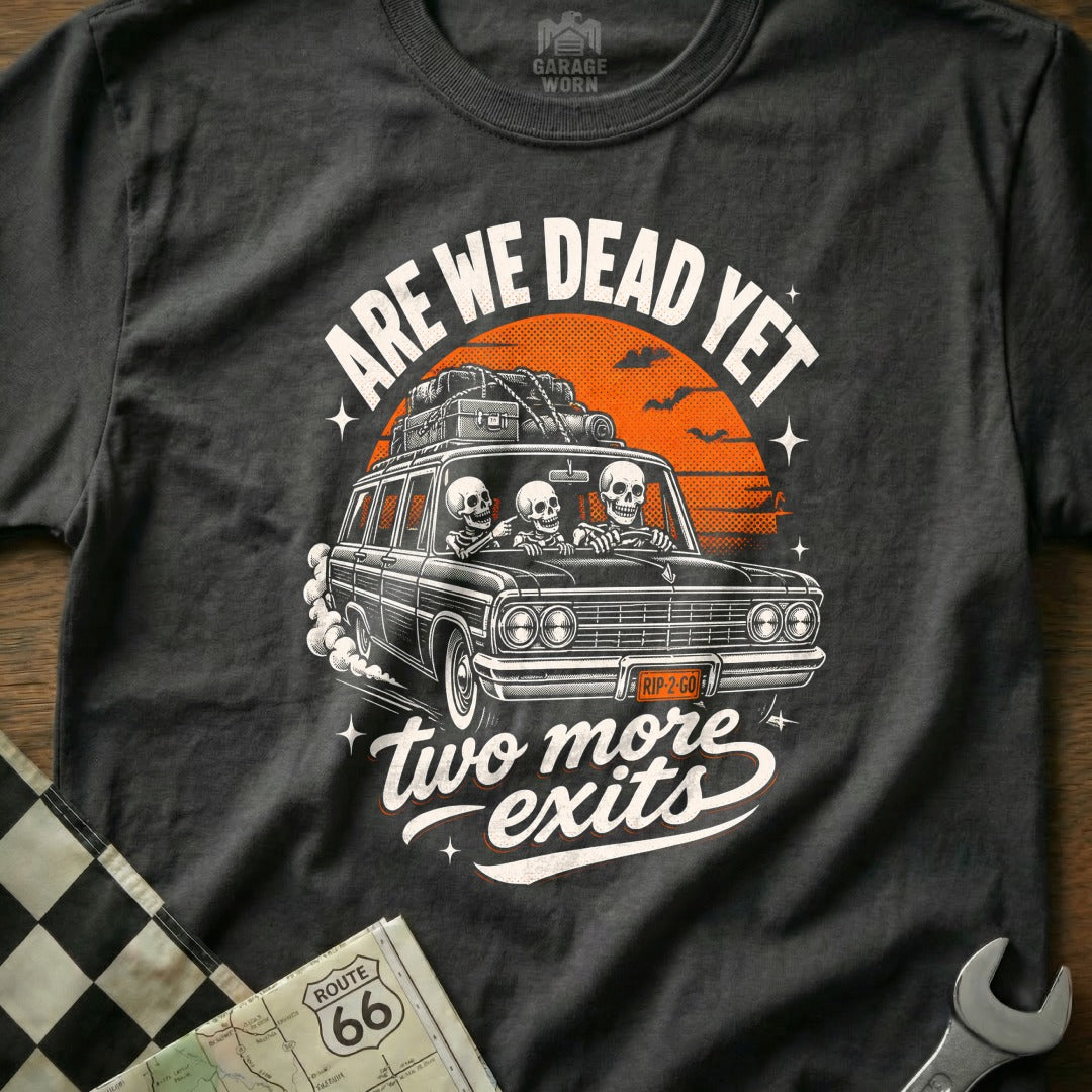 T-shirt with skeletons driving a car, "Are We Dead Yet," and "Two More Exits."