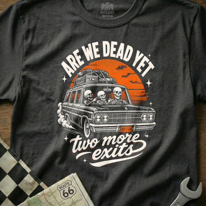 T-shirt with skeletons driving a car, "Are We Dead Yet," and "Two More Exits."