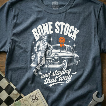 Skeleton leaning on car with "Bone Stock and staying that way" text.