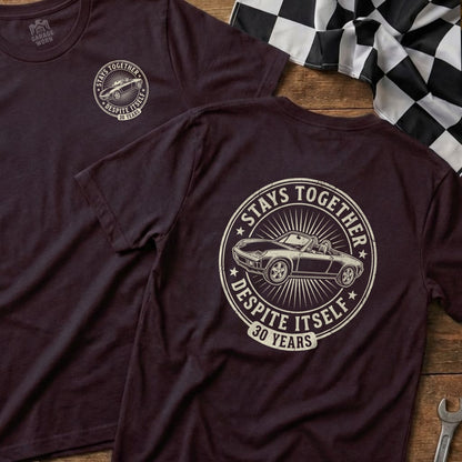 Burgundy t-shirt with circular graphic of convertible car, "Stays Together Despite Itself 30 Years".