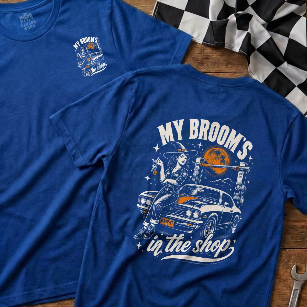 Blue t-shirt with witch and car graphic: "My Broom's in the shop".