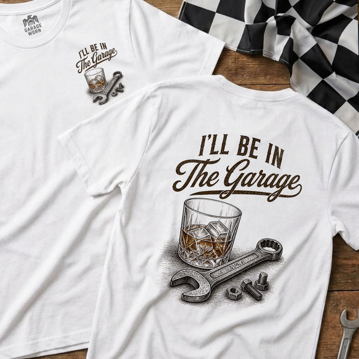 White t-shirt with "I'll Be In The Garage" text, whiskey glass, and wrench graphic.