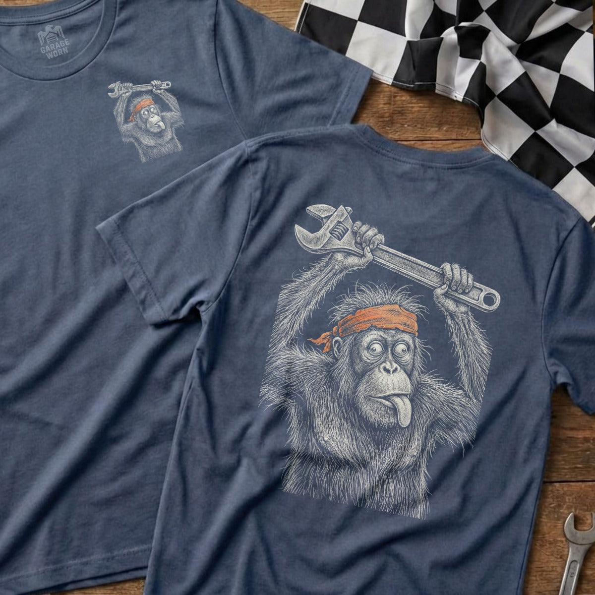 T-shirt with orangutan holding a wrench and sticking out its tongue.
