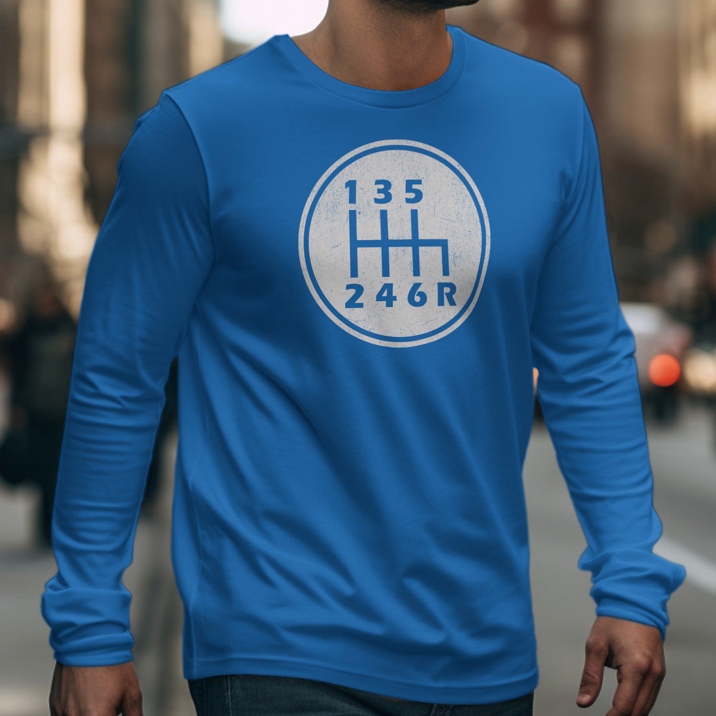 Blue long-sleeve shirt with a white six-speed manual transmission gear shift pattern graphic.