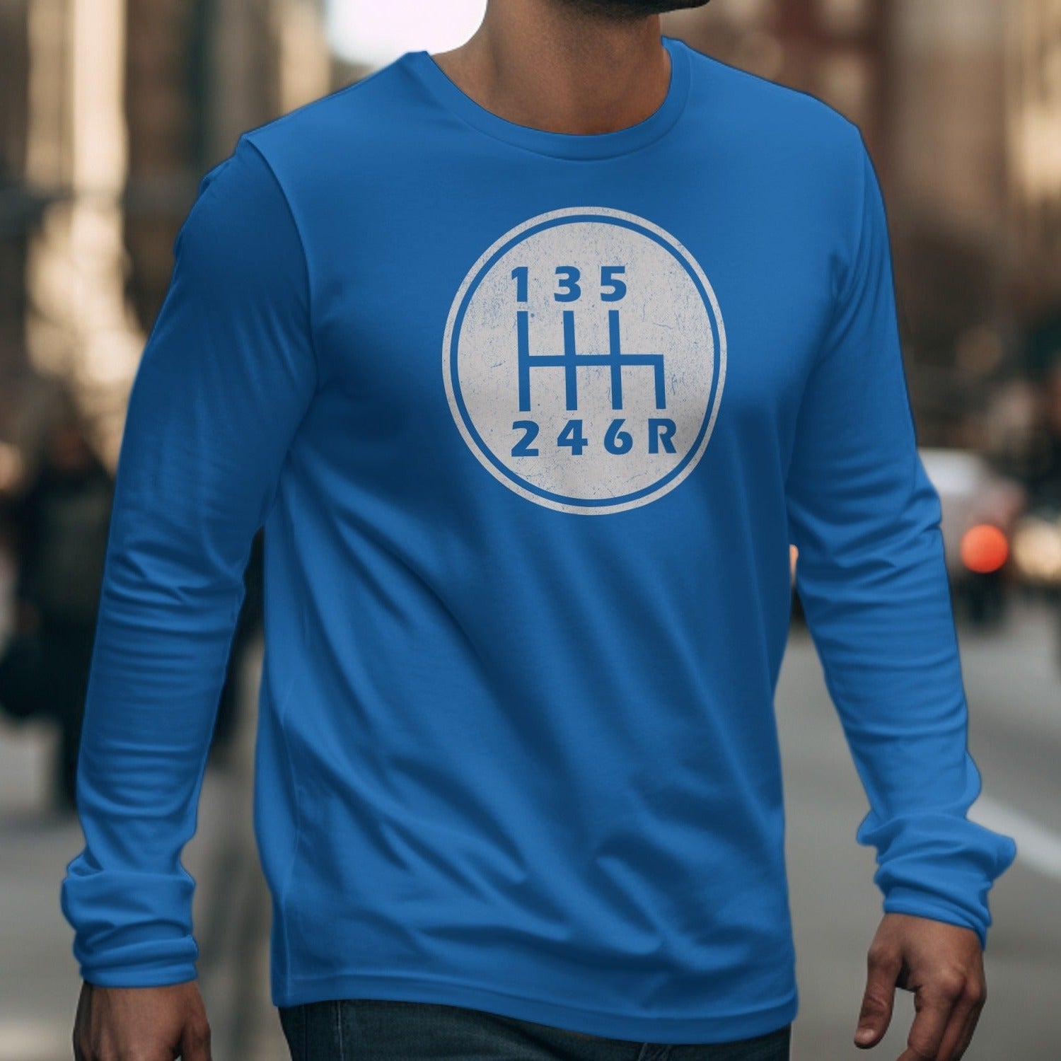 Blue long-sleeve shirt with a white six-speed manual transmission gear shift pattern graphic.