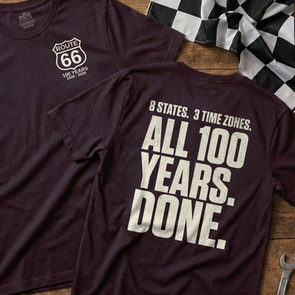 Burgundy t-shirt with Route 66 logo and text "100 Years 1926-2026" on front, "8 States. 3 Time Zones. All 100 Years. Done." on back.