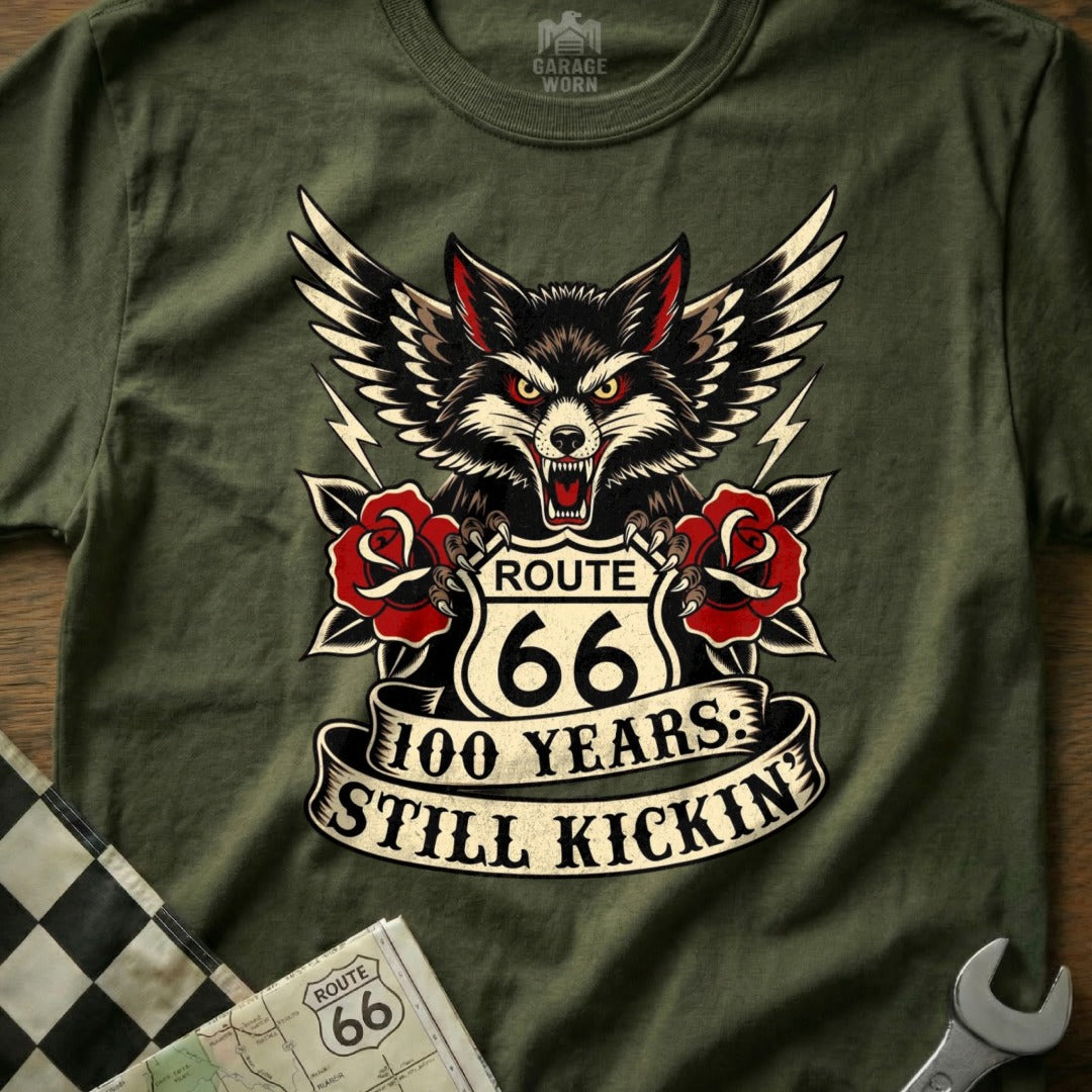 Wolf with wings, Route 66 100 Years Still Kickin' graphic on a green t-shirt.