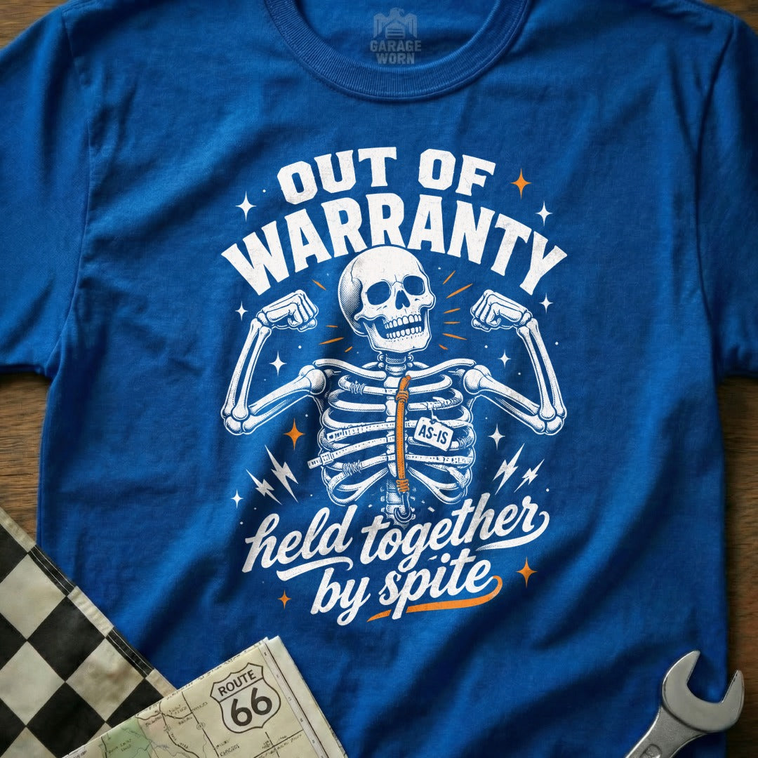 Blue t-shirt with skeleton graphic saying "Out of Warranty, Held Together by Spite".