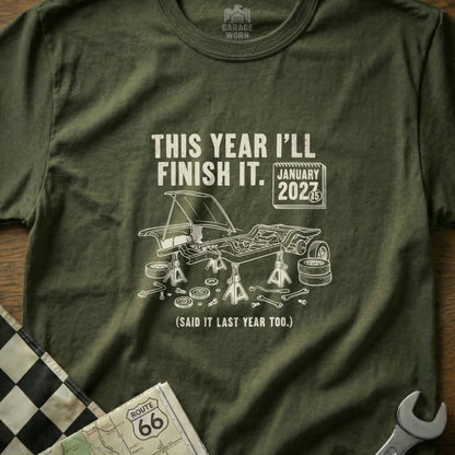Olive green t-shirt with "This Year I'll Finish It. January 2027" and car graphic.