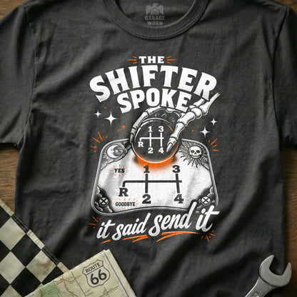 The Shifter Spoke t-shirt features a skeleton hand on a manual transmission shift pattern with "it said send it".