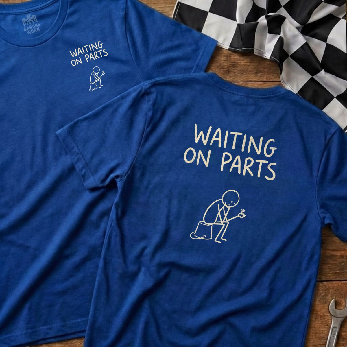 Blue t-shirts with "Waiting On Parts" graphic, checkered flag in background.