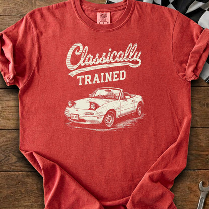 Red t-shirt with white text "Classically TRAINED" and a drawing of a convertible car.
