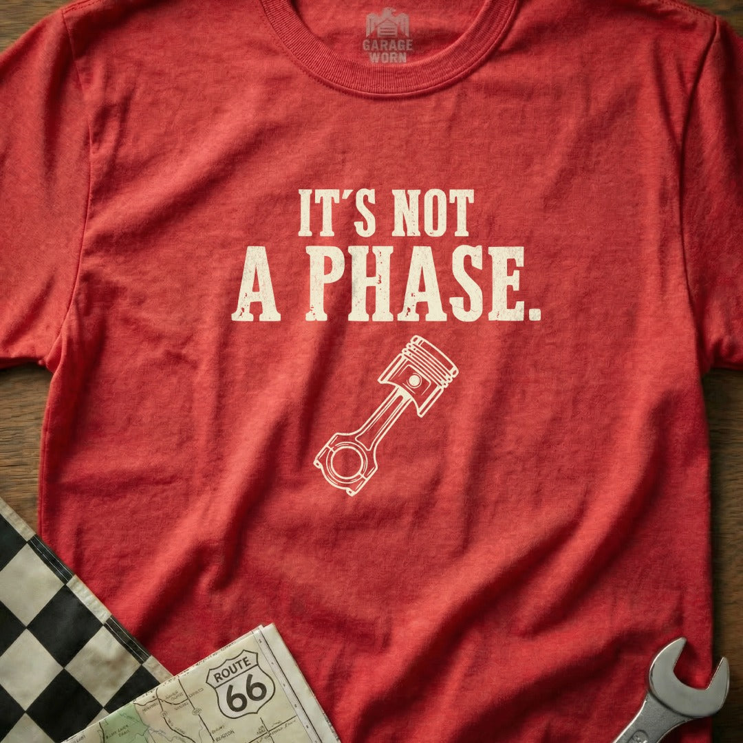 Red t-shirt with "It's NOT A PHASE." and piston graphic.