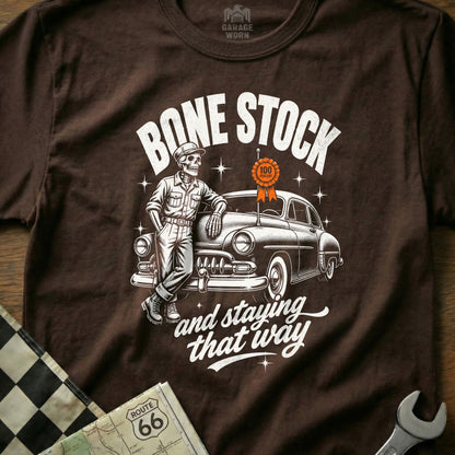 Skeleton leaning on classic car with text "Bone Stock and staying that way".