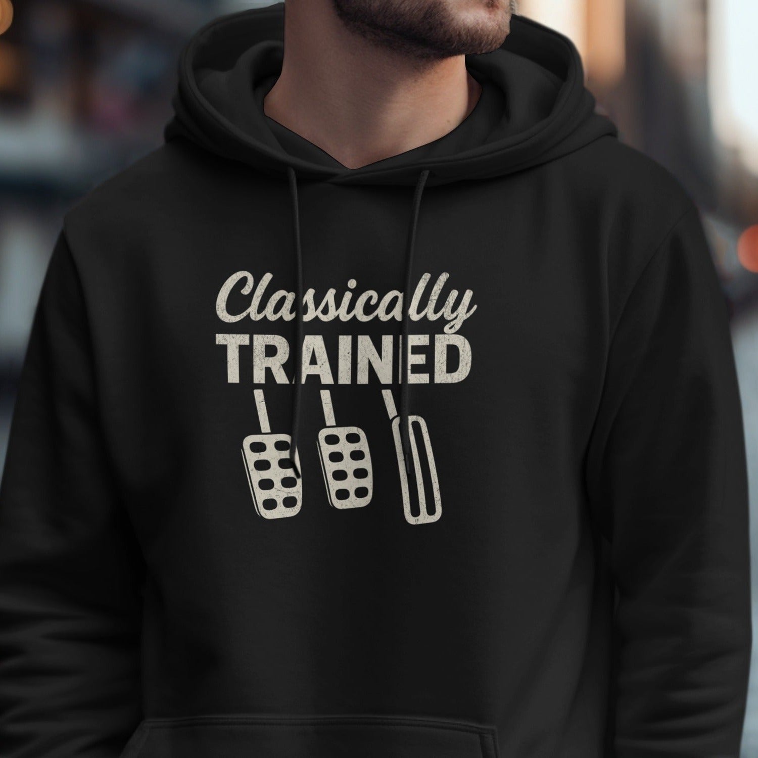 Black hoodie with "Classically TRAINED" text and three car pedals.