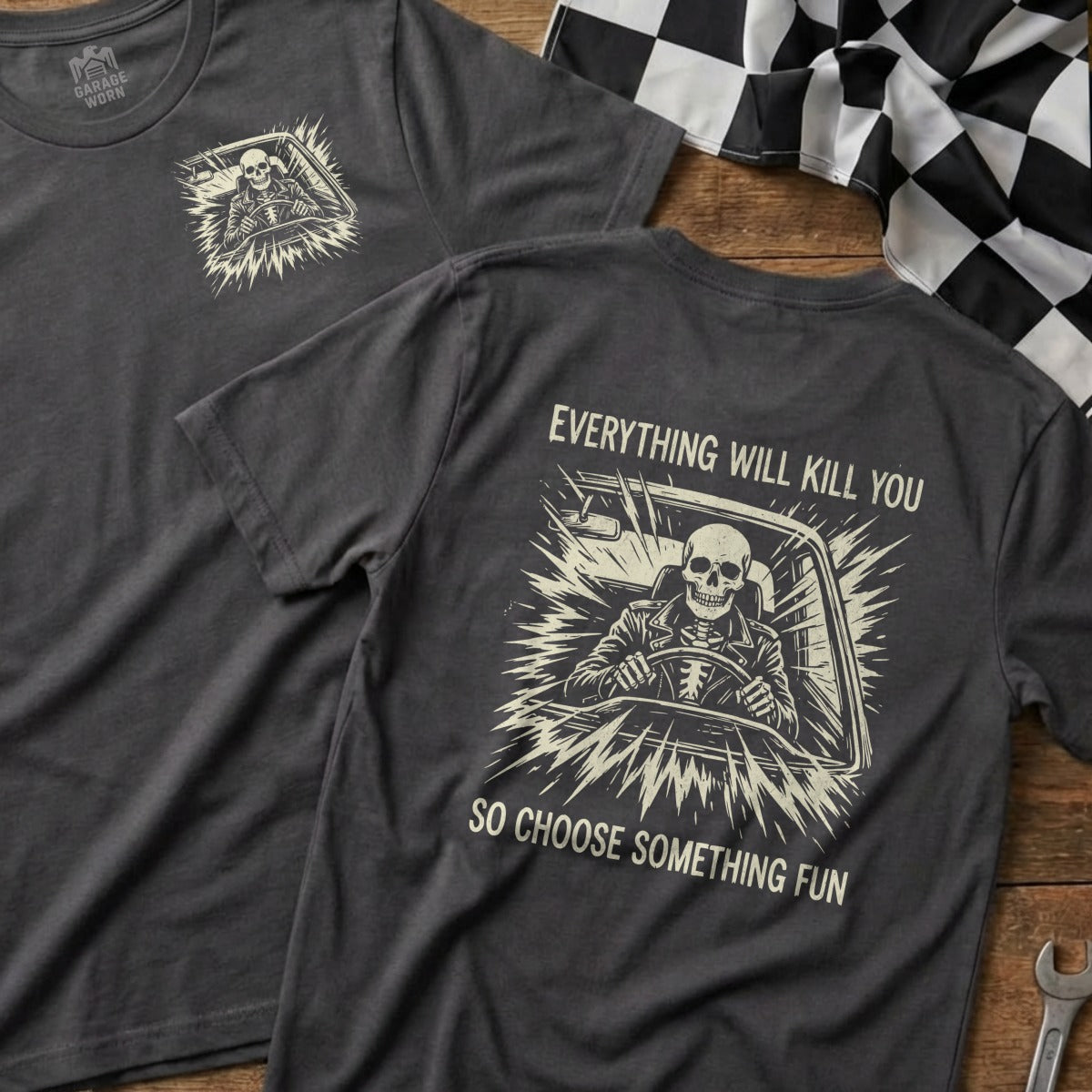 Dark grey t-shirt with skull driving car graphic and text "Everything will kill you. So choose something fun."