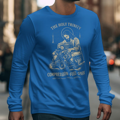 Blue long sleeve shirt with graphic: "The Holy Trinity" and Jesus working on an engine.