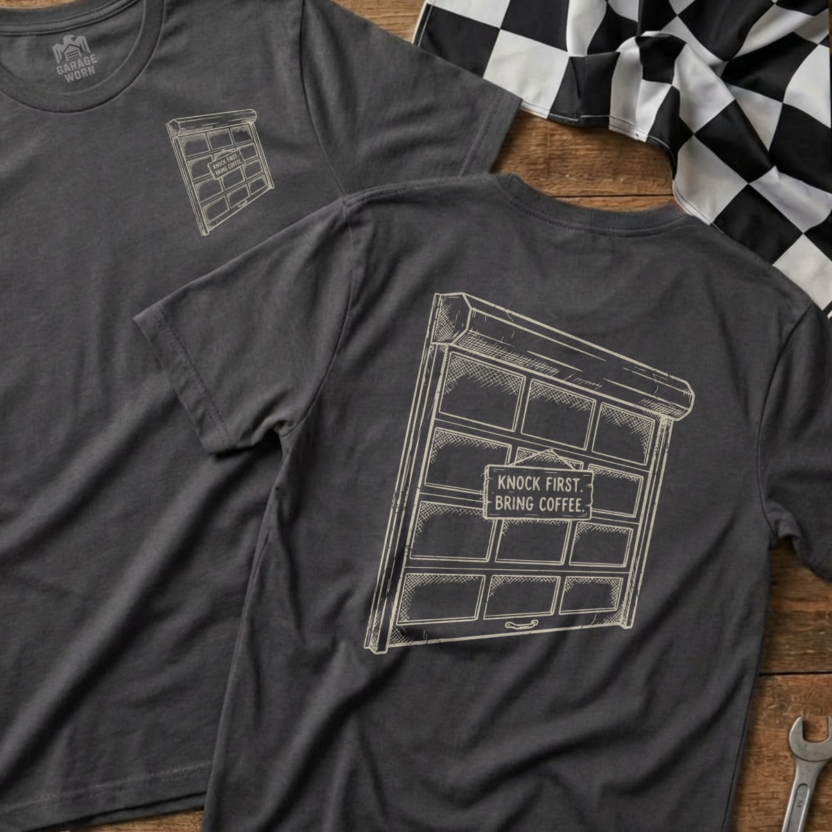 Dark grey t-shirt with a sketch of a garage door and text.